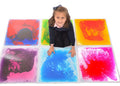 Girl sitting on a 3x2 grid of six colorful, 50cm square liquid floor tiles with swirling marbled patterns.