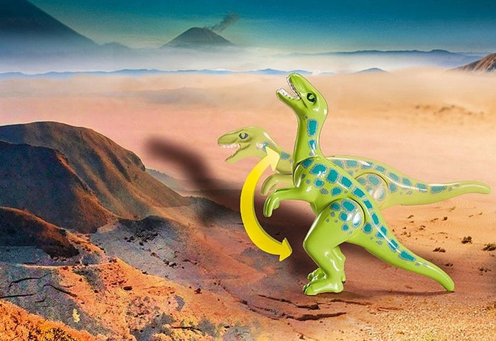 Green toy dinosaur with blue spots and a movable neck shown in a desert landscape with a distant volcano.
