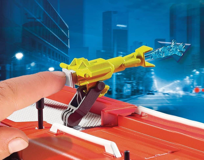 Finger launches a blue water projectile from a yellow cannon on a red toy fire engine's roof.