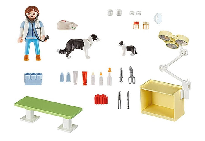 Playmobil vet set with figure, cat, two dogs, medical tools, green exam table, and yellow operating light station.