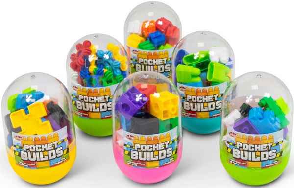 Six egg-shaped clear capsules filled with colorful building blocks, each with a vibrant solid-colored base.