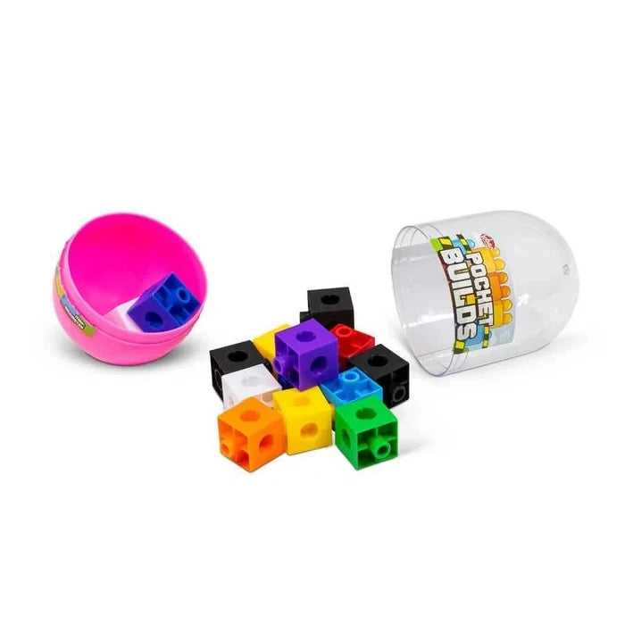 Colorful interlocking cubes with circular cutouts spill out of a pink and clear plastic capsule container.