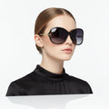 Black dealonlinenz sunglasses with polarized lenses and rhinestone detail, stylish sun eyewear with decorative embellishments.