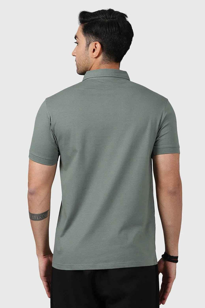 Sage green Polo T-shirt by Fuaark Nz, made of soft fabric, featuring a classic collar and short sleeves.