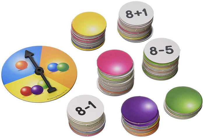 Colorful game spinner beside stacks of round tokens, some showing addition and subtraction problems like 8+1 and 8-5.
