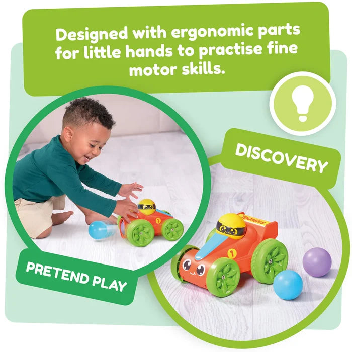 A toddler plays with a red toy race car featuring green wheels and a yellow driver, accompanied by colorful balls.