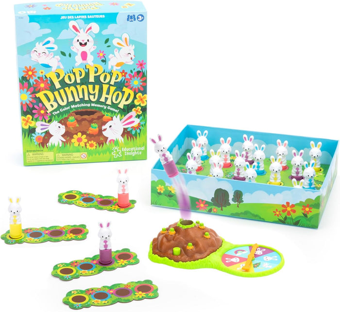 Board game box with jumping bunny hill, spinner, and colorful rabbit figurines on a flowery meadow-themed board.