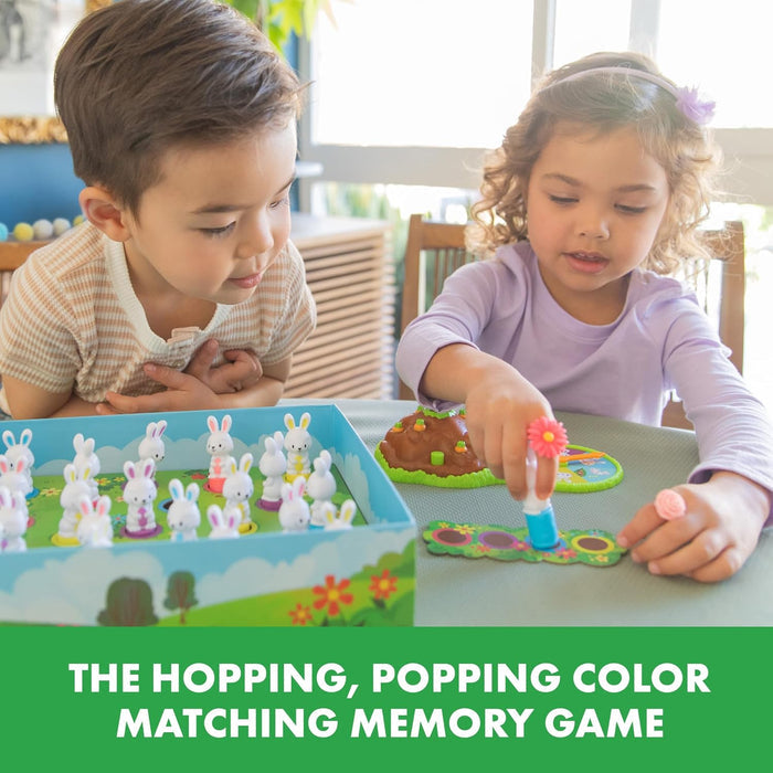 Two children play a board game with white plastic bunny figures, colorful bases, and a pink flower stamper tool.