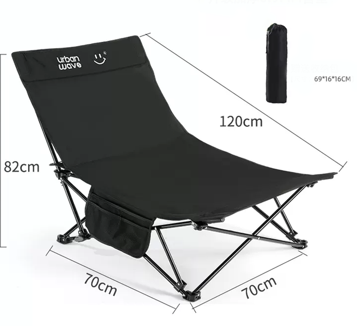 Black ECOTREK portable folding beach chair with enhanced size and comfort, showing its frame and padded seat.