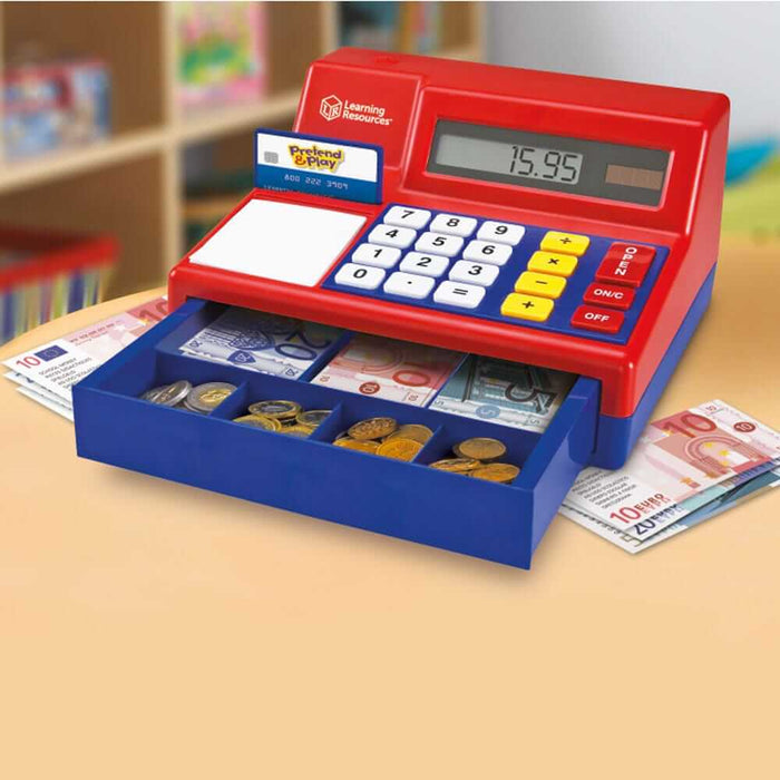 Red and blue toy register with an open drawer of Euro play money, digital screen showing 15.95, and credit card.