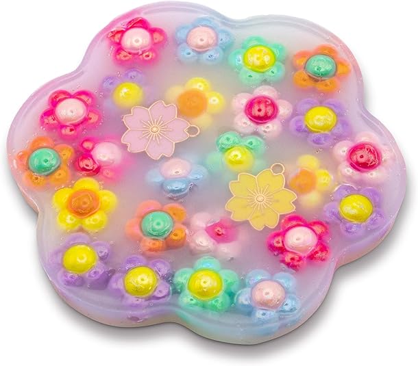 Translucent purple flower-shaped sensory toy filled with colorful flower beads and two small floral charms.