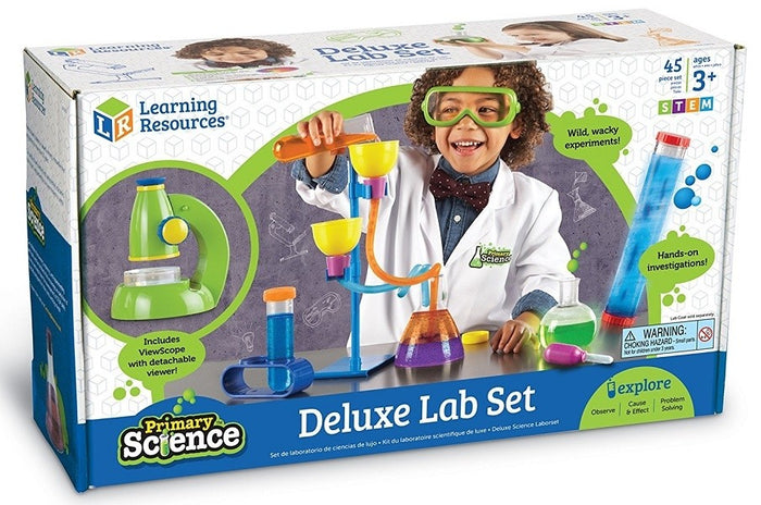 Science kit box showing a child using colorful plastic flasks, funnels, and a green toy microscope.