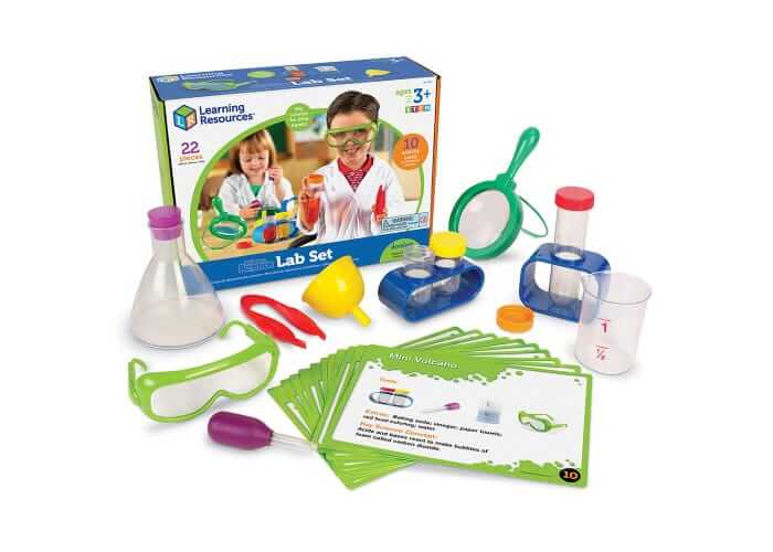 Brightly colored plastic flask, beaker, goggles, and magnifying glass displayed with the box and activity cards.