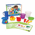 Colorful kids measurement set with a blue scale, measuring cups, spoons, and activity cards in front of product box.