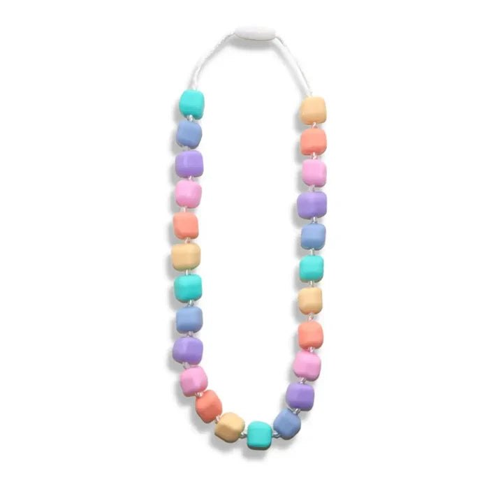 Pastel rainbow chewable necklace with rounded cube beads on a white cord with a breakaway safety clasp.