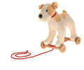Fuzzy white and tan plush dog on a wooden four-wheeled base with a red collar and a long red pull string.
