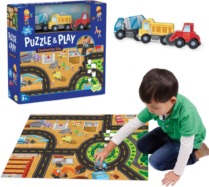 Blue puzzle box, three wooden toy vehicles, and a boy playing on a colorful 48-piece construction site floor puzzle.