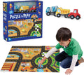 Blue puzzle box, three wooden toy vehicles, and a boy playing on a colorful 48-piece construction site floor puzzle.