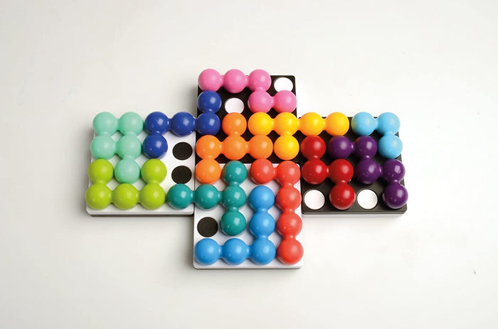 Colorful spherical puzzle pieces arranged on four interlocking black and white grid boards.