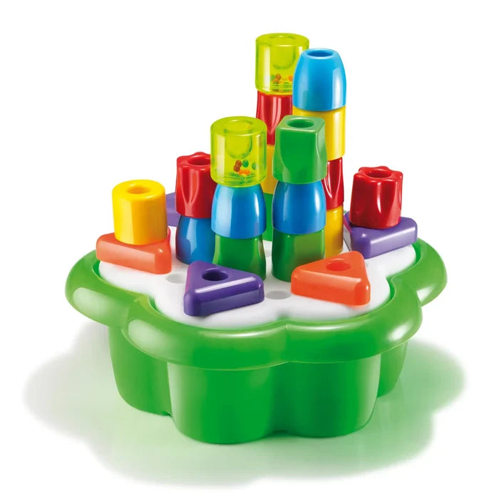 Colorful chunky plastic pegs in various shapes stacked on a green flower-shaped base.