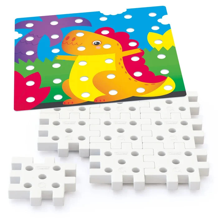 White interlocking plastic pegboard tiles below a colorful cartoon dinosaur card with circular cutouts.