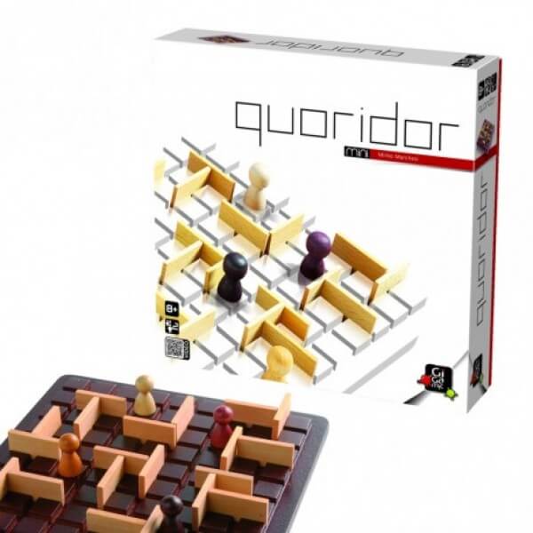 Quoridor Mini box next to a dark wood grid board with light tan maze walls and small colorful wooden pawns.