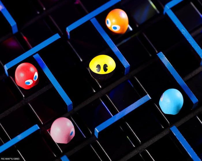 Pac-Man and four colorful ghosts as game pieces navigate a dark grid board with blue maze walls.