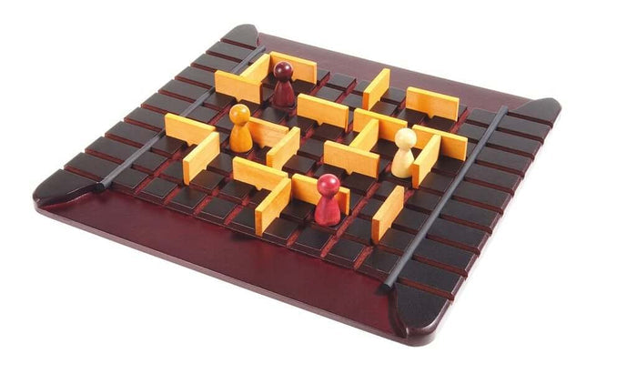 Wooden strategy board game with a dark grid, light wood maze walls, and four colored wooden pawns.