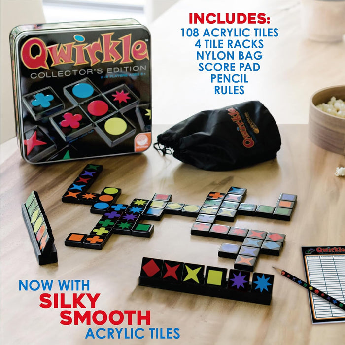 Qwirkle Collector's Edition tin box with black acrylic tiles, colorful shapes, tile racks, score pad, and storage bag.