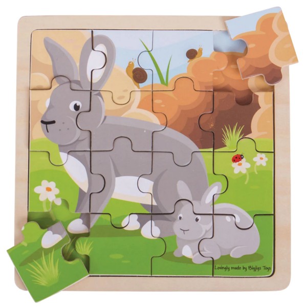 16-piece wooden puzzle of a large and small grey rabbit in a grassy meadow. Two puzzle pieces are set aside.