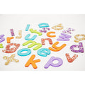 Colorful, translucent glitter lowercase letters scattered on a white background.