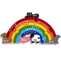 Wooden arched rainbow with Irish colour names and animal pieces: black cat, brown dog, pink pig, white sheep, grey seal.