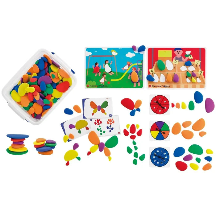 Colorful smooth pebbles in a clear bin with activity mats, spinners, and creative designs on a white background.