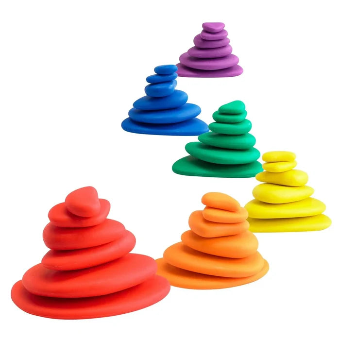 Six stacks of smooth, flat pebbles in red, orange, yellow, green, blue, and purple, sorted by color and size.