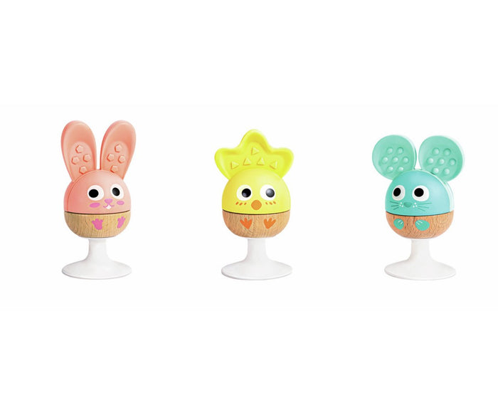 Three egg-shaped animal rattles: pink bunny, yellow chick, and blue mouse with textured ears and wooden bases.