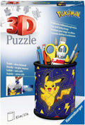 Blue box showing a cylindrical 3D puzzle pencil cup with Pikachu, filled with scissors, pens, and paintbrushes.