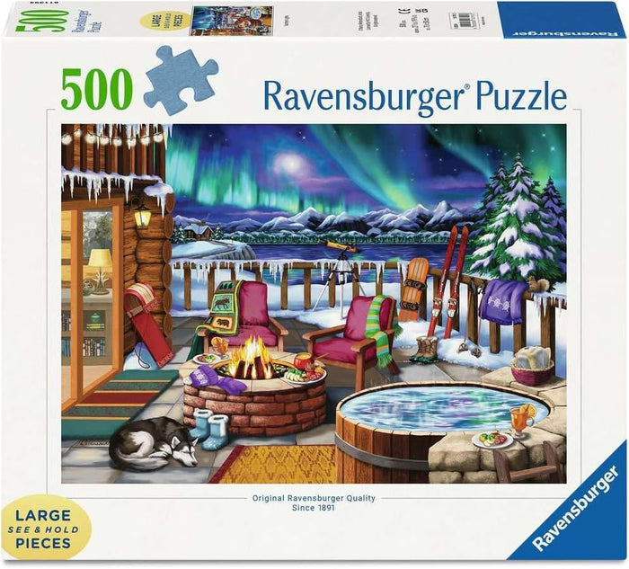 500-piece puzzle box showing a winter patio with a fire pit and sleeping dog under a vibrant green aurora borealis sky.