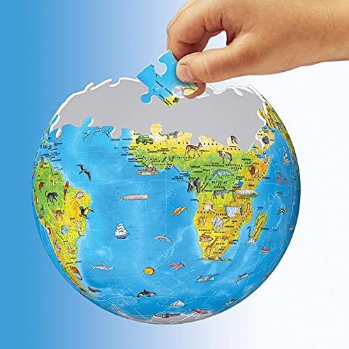 Hand placing a piece into a 3D globe puzzle featuring a colorful world map with illustrated animals and landmarks.