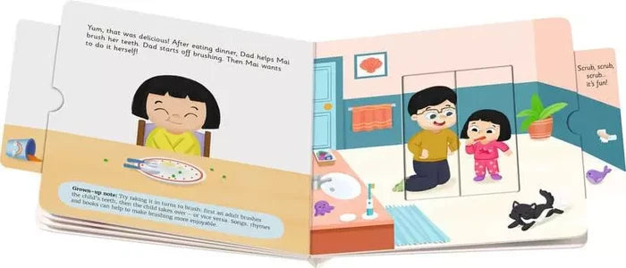 Open board book with colorful cartoon illustrations of a girl eating dinner and brushing teeth with her father.