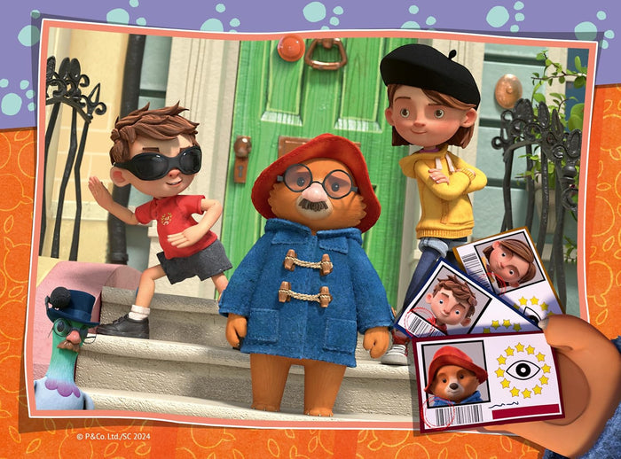 Paddington in a disguise, Judy, and Jonathan by a green door. A hand holds their three ID cards in the foreground.