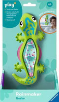 Lime green gecko toy with a bead-filled clear belly in teal packaging. Shows suction cup feature for bath time.