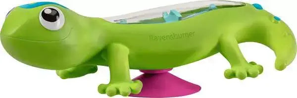 Green toy gecko with a clear, bead-filled back, large eyes, and a pink suction cup base.