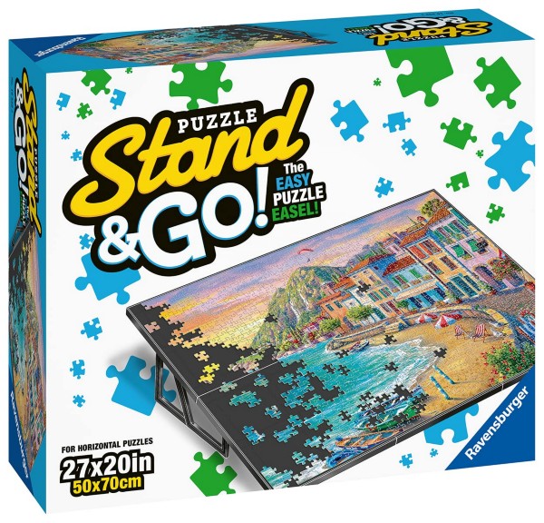 Product box showing a tilted black board with a coastal landscape puzzle and colorful scattered puzzle piece graphics.