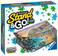 Product box showing a tilted black board with a coastal landscape puzzle and colorful scattered puzzle piece graphics.