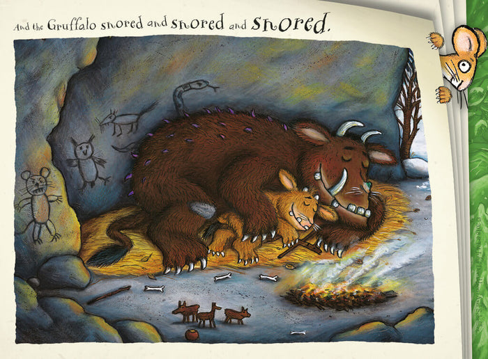 The Gruffalo and child sleep in a cave with wall drawings and a mouse peeking from a corner.