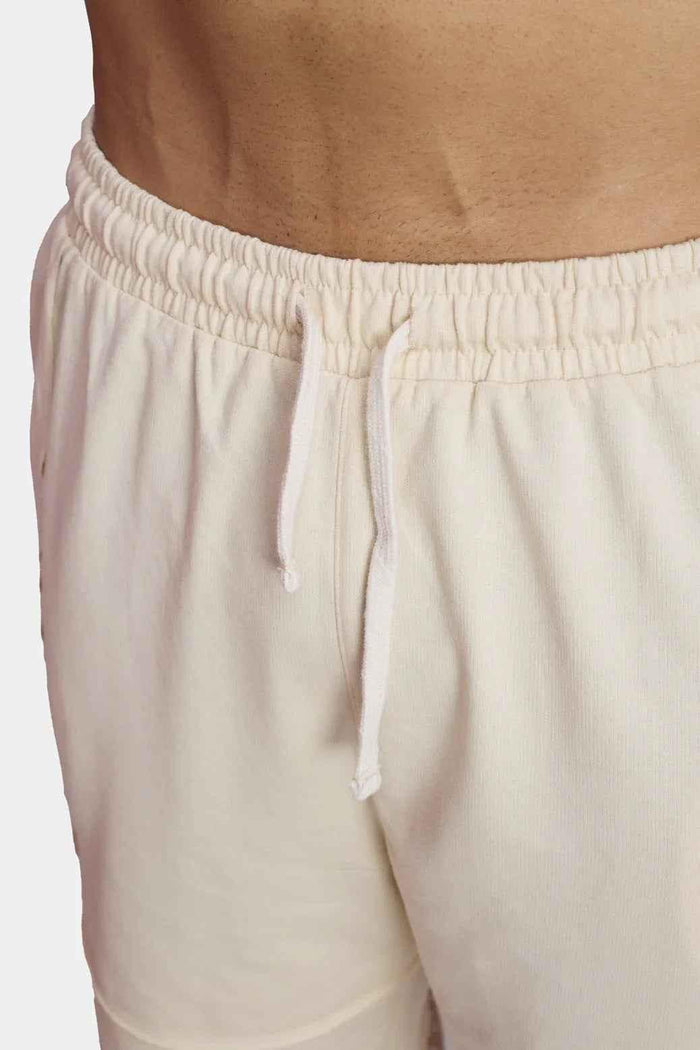 Beige raw edge oversized shorts from Fuaark Nz, casual fit with distressed hem, made from lightweight fabric.