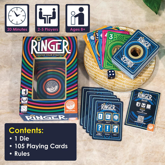 Ringer card game box with colorful rings, a stack of hole-punched cards, a blue die, and rules for 2-5 players.