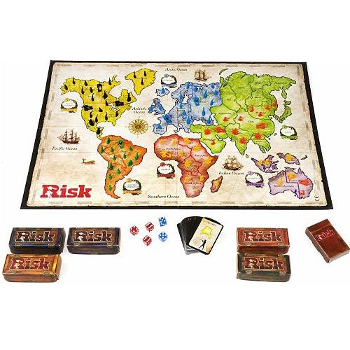 Risk board game with world map, colorful plastic army pieces, dice, and game cards against a white background.