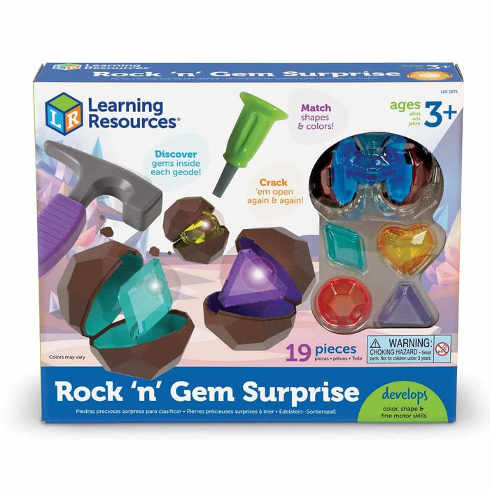 Toy box featuring a plastic hammer, chisel, open brown geodes, and colorful translucent gems in various shapes.