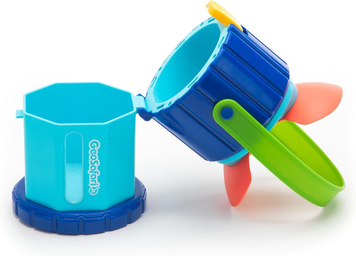 Light blue hexagonal GeoSafari Jr. toy with a dark blue hinged magnifying lid, green handle, and orange fins.